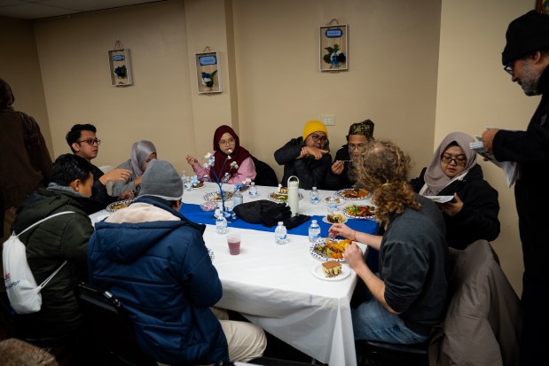 Participants of the Chicago Black Muslim History Tour join members of Masjid Al-Taqwa for lunch after Friday prayer at the mosque in the Calumet Heights neighborhood, Dec. 6, 2024. (E. Jason Wambsgans/Chicago Tribune)