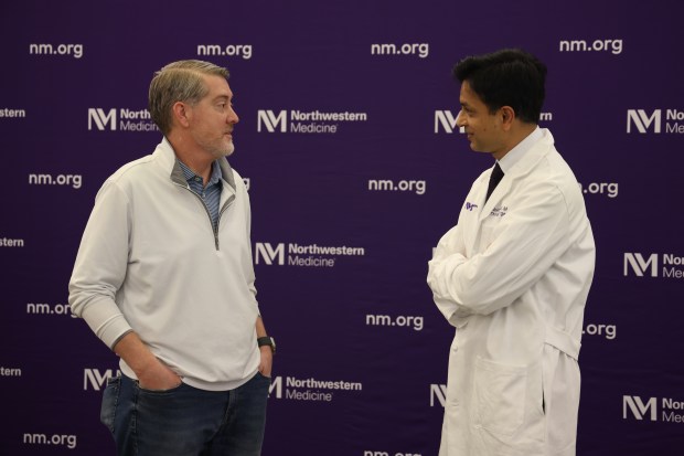 Lung transplant patient Tadd Crosslin, left, speaks with Chief of Thoracic Surgery and Director of the Canning Thoracic Institute, Dr. Ankit Bharatat, following a press conference at Northwestern Medicine on Feb. 5, 2025. (Antonio Perez/Chicago Tribune)