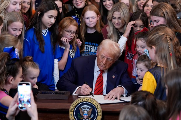 President Donald Trump signs an executive order barring transgender female athletes from competing in women's or girls' sporting events, in the East Room of the White House, Feb. 5, 2025, in Washington. (Alex Brandon/AP)