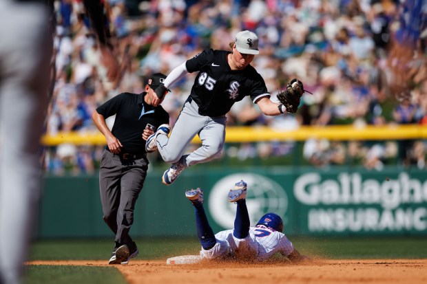 Cubs left fielder Christian Franklin steals second base past White Sox second baseman Chase Meidroth on Feb. 22, 2025, at Sloan Park in Mesa, Ariz. (Armando L. Sanchez/Chicago Tribune)