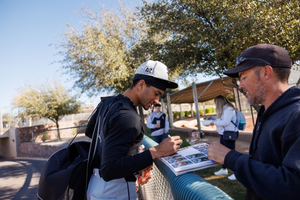 White Sox outfielder Braden Montgomery signs autographs during spring training at Camelback Ranch on Feb. 15, 2025, in Glendale, Ariz.(Armando L. Sanchez/Chicago Tribune)