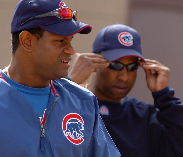 Sammy Sosa and Julian Martinez head to the field March 2, 2004, in Mesa, Ariz. (Phil Velasquez/Chicago Tribune)