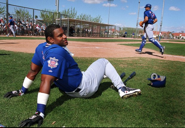 Sammy Sosa takes a break on the field after batting practice Feb. 28, 2000, in Mesa, Ariz. (Heather Stone/Chicago Tribune)