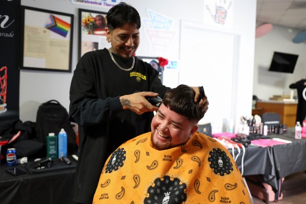 Barber Davtrious Sanchez gives Santiago Troncoso a haircut during a free gender-affirming haircut event at the TransChicago Empowerment Center in Humboldt Park on Feb. 10, 2025. (Eileen T. Meslar/Chicago Tribune)