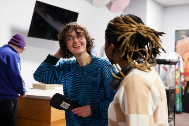 Sarah, left, smiles as they check out their new haircut in the mirror at the TransChicago Empowerment Center in Humboldt Park on Feb. 10, 2025. (Eileen T. Meslar/Chicago Tribune)