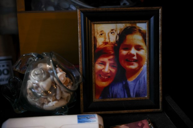 A framed photo of Ben Garcia and his mother Michelle Vallet is displayed on a shelf in their Rogers Park apartment. (Eileen T. Meslar/Chicago Tribune)