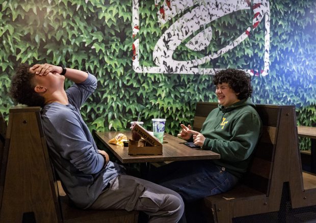 Ben Garcia, right, and his friend Verlander Thompkins III hang out at Taco Bell after school on Feb. 13, 2025. (Eileen T. Meslar/Chicago Tribune)