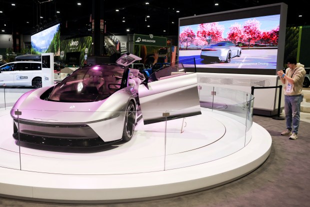 An attendee photographs a Chrysler All-Electric Halcyon concept vehicle during the media preview day at the 2025 Chicago Auto Show at McCormick Place on Feb. 6, 2025. (Eileen T. Meslar/Chicago Tribune)