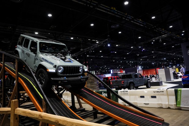 People ride in a 2025 Jeep Wrangler Rubicon 4xE hybrid in the Camp Jeep experience during the media preview day at the 2025 Chicago Auto Show at McCormick Place on Feb. 6, 2025. (Eileen T. Meslar/Chicago Tribune)