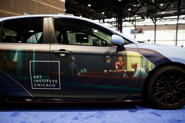 A Toyota Camry decorated with the 1942 Edward Hopper painting "Nighthawks" will be the NASCAR Chicago Street Race pace car. It's displayed during a media preview day at the 2025 Chicago Auto Show at McCormick Place on Feb. 6, 2025. (Eileen T. Meslar/Chicago Tribune)