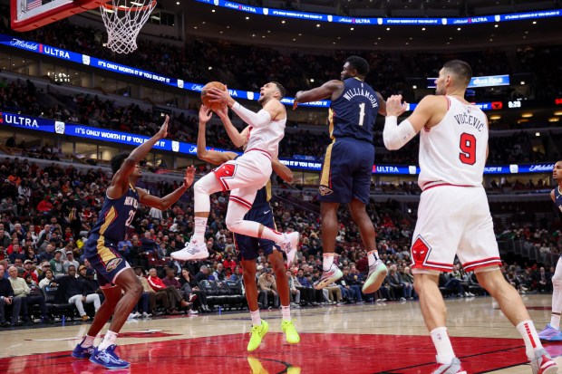 New Orleans Pelicans forward Zion Williamson (1) fouls Chicago Bulls guard Zach LaVine (8) while he goes up for a basket during the third period at the United Center Tuesday Jan. 14, 2025, in Chicago. (Armando L. Sanchez/Chicago Tribune)