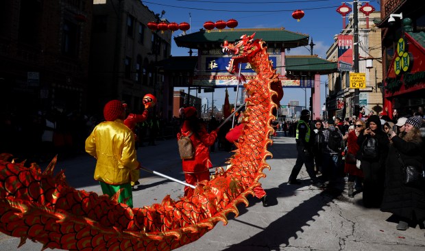 People perform a dragon dance in the Lunar New Year parade in Chinatown on Feb. 9, 2025. (Eileen T. Meslar/Chicago Tribune)