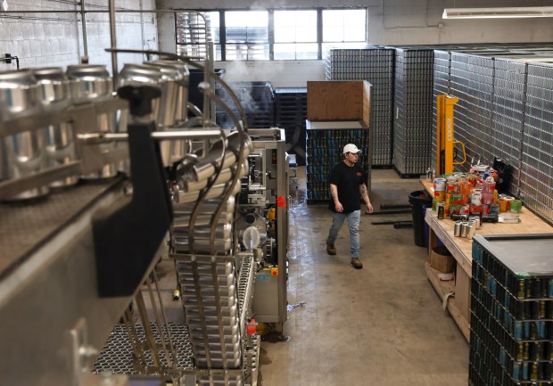 Tyler Dierkes walks through the production floor at BevWrap on Feb. 20, 2025, in Elk Grove Village. (Stacey Wescott/Chicago Tribune)