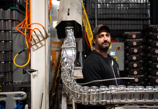 Jason Klein, co-founder of Spiteful Brewing in the Bowmanville neighborhood, at the brewery Feb. 24, 2025. He said the 13-year-old brewery sells a half-million cans each year, all imported from Canada through a supplier. If the 25% tariffs hit, Klein expects that Spiteful will have to raise prices to cover the additional cost. (E. Jason Wambsgans/Chicago Tribune)