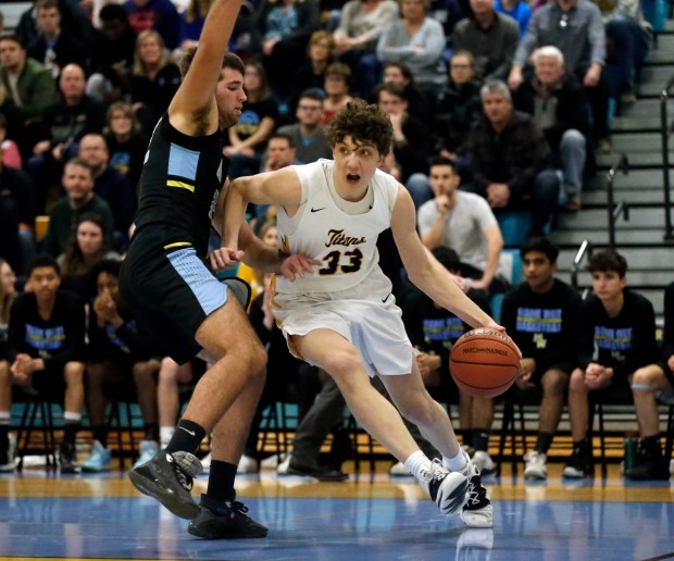 Glenbrook South's Nick Martinelli (33) holds off Maine West's Dan Kentgen (22) during their 65-49 win at the Maine West regional final in Des Plaines, Friday March 6, 2020. (Kevin Tanaka/Pioneer Press)