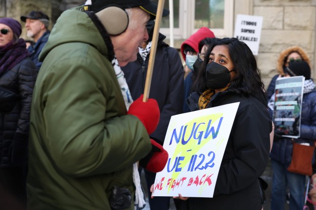 Northwestern University graduate student Mounica Sreesai, right, talks with a fellow demonstrator during the People's March for Justice at Water Tower Park on Jan. 25, 2025, in Chicago. (John J. Kim/Chicago Tribune)