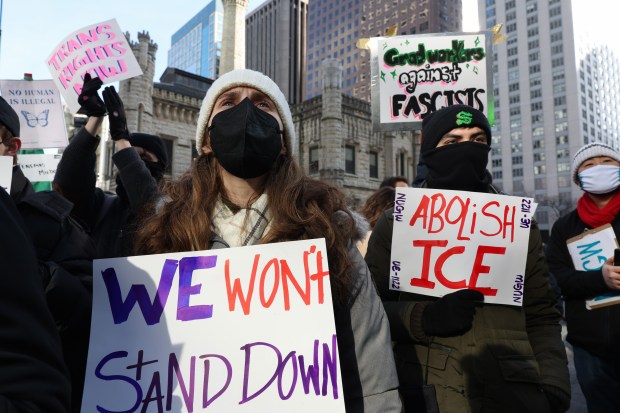 A Northwestern University graduate student, left, and colleagues attend the People's March for Justice at Water Tower Park on Jan. 25, 2025, in Chicago, in response to recent actions by President Donald Trump. (John J. Kim/Chicago Tribune)