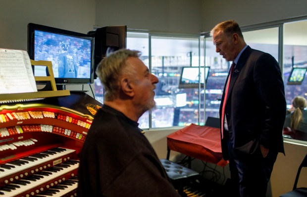 Jim Cornelison meets organist Frank Pellico at the top of the United Center for a warmup before he sang the Star Spangled Banner on Sunday, Nov. 10, 2019. (Brian Cassella/Chicago Tribune)