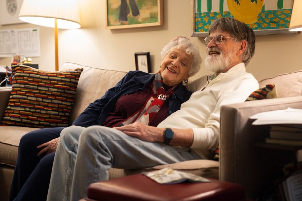 Sanna Longden and Clint Seely share a moment on the couch before heading to a show, Jan. 31, 2025. (Audrey Richardson/Chicago Tribune)