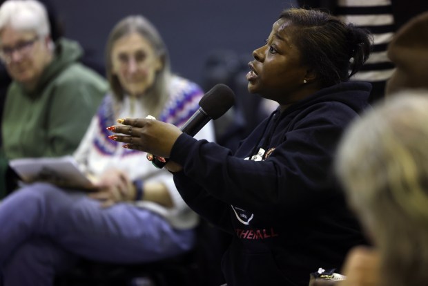 An attendee asks a question to Deputy Mayor of Community Safety Garien Gatewood during a town hall meeting at Amberg Hall Bethel New Life on Feb. 23, 2025. (Antonio Perez/Chicago Tribune)