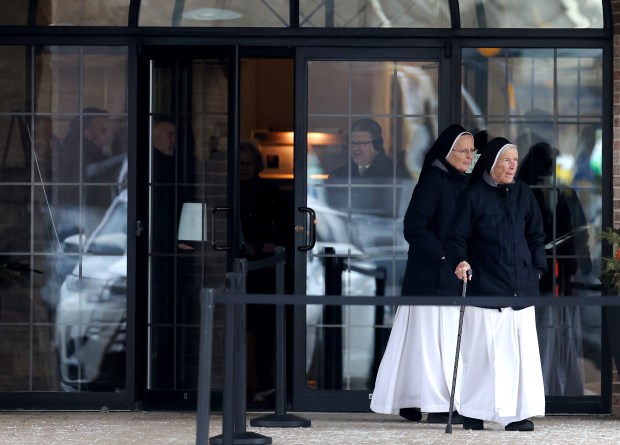 Two nuns exit Oehler Funeral Home in Des Plaines after attending the visitation for late Chicago Bears owner Virginia McCaskey on Tuesday, Feb. 11, 2025. The daughter of Bears team founder George Halas, McCaskey died on Feb. 6 at the age of 102. (Chris Sweda/Chicago Tribune)