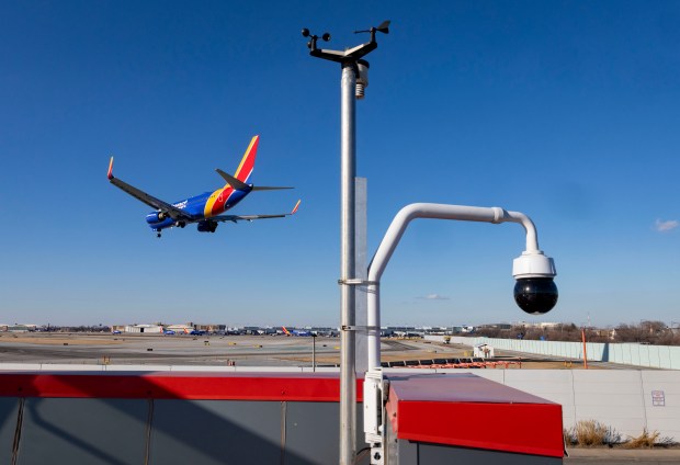 A Southwest Airlines plane lands at Midway International Airport while being filmed by a remotely-operated camera on the roof of Pro Auto repair shop on Feb. 25, 2025, after the camera caught a near collision between two planes earlier in the day. (Brian Cassella/Chicago Tribune)