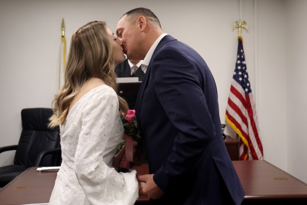 Anna and Vitaliy Hafych exchange wedding vows with Judge Pedro Fiegoso on Valentine's Day at City Hall, Feb. 14, 2025. "We chose Valentine's Day because it is a day for people in love," said Vitaliy. (Antonio Perez/Chicago Tribune)