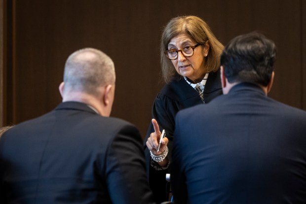 Judge Victoria A. Rossetti discusses a possible juror with Assistant State's Attorney Eric Kalata, left, and Public Defender Gregory Ticsay on day three of jury selection in the Robert Crimo III trial at the Lake County Courthouse, Feb. 26, 2025, in Waukegan. (Ashlee Rezin/Chicago Sun-Times)