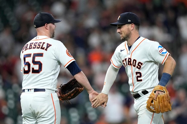 Houston Astros' Alex Bregman (2) and Ryan Pressly (55) celebrate after a baseball game against the Los Angeles Angels Thursday, June 1, 2023, in Houston. The Astros won 5-2. (AP Photo/David J. Phillip)