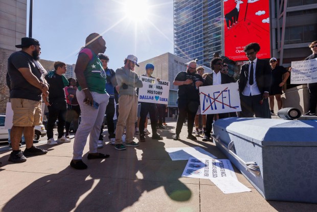 Fans gather near a coffin and tribute to Luka Doncic after he was traded from the Dallas Mavericks to the Los Angeles Lakers outside the American Airlines Center, Sunday, Feb. 2, 2025, in Dallas. (Elias Valverde II/The Dallas Morning News/TNS)