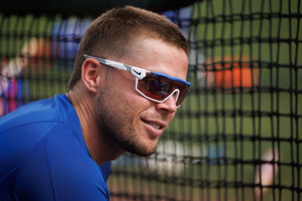 Cubs second baseman Nico Hoerner sits near the side of a practice field during spring training on Feb. 13, 2025, at Sloan Park in Mesa, Ariz. (Armando L. Sanchez/Chicago Tribune)