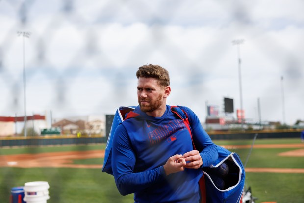 Cubs catcher Carson Kelly walks on a practice field during spring training on Feb. 13, 2025, at Sloan Park in Mesa, Ariz. (Armando L. Sanchez/Chicago Tribune)