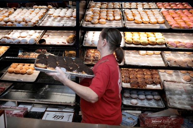 Employees keep busy as customers flock to Weber's Bakery on Archer Avenue in Chicago, to pick up their boxes of Paczki for Fat Tuesday on Feb. 13, 2024. (Antonio Perez/ Chicago Tribune)