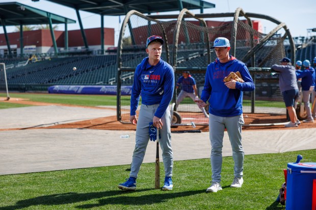 Cubs center fielder Pete Crow-Armstrong, left, talks with manager Craig Counsell during spring training at Sloan Park on Feb. 19, 2025, in Mesa, Ariz. (Armando L. Sanchez/Chicago Tribune)