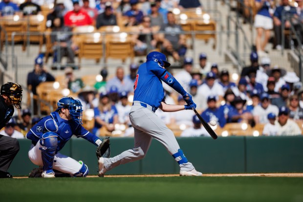 Chicago Cubs first base Michael Busch (29) hits a single during the first inning against the Los Angeles Dodgers at spring training at Camelback Ranch Thursday Feb. 20, 2025, in Glendale, Arizona. (Armando L. Sanchez/Chicago Tribune)