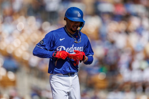 Los Angeles Dodgers shortstop Mookie Betts (50) gets walked during the first inning against the Chicago Cubs at spring training at Camelback Ranch Thursday Feb. 20, 2025, in Glendale, Arizona. (Armando L. Sanchez/Chicago Tribune)