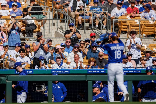 Los Angeles Dodgers pitcher Yoshinobu Yamamoto (18) walks to the dugout after being taken out by Los Angeles Dodgers manager Dave Roberts (30) during the second inning against the Chicago Cubs during spring training at Camelback Ranch Thursday Feb. 20, 2025, in Glendale, Arizona. (Armando L. Sanchez/Chicago Tribune)