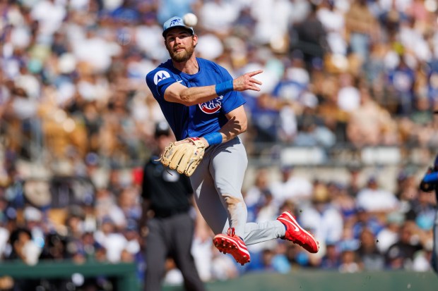 Chicago Cubs third base Gage Workman (25) throws to Chicago Cubs first base Michael Busch (29) to tag out Los Angeles Dodgers second base Hyeseong Kim (6) during the second inning at spring training at Camelback Ranch Thursday Feb. 20, 2025, in Glendale, Arizona. (Armando L. Sanchez/Chicago Tribune)