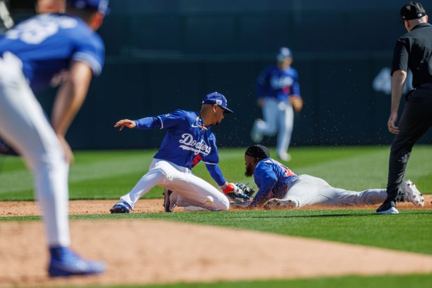 Chicago Cubs shortstop Vidal Bruján (17) steals second base past Los Angeles Dodgers shortstop Mookie Betts (50) during the third inning at spring training at Camelback Ranch Thursday Feb. 20, 2025, in Glendale, Arizona. (Armando L. Sanchez/Chicago Tribune)