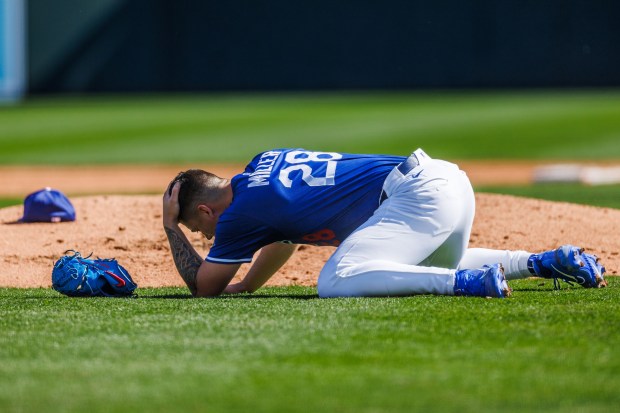 Los Angeles Dodgers pitcher Bobby Miller (28) gets hit by a pitch from Chicago Cubs first base Michael Busch (29) during the third inning at spring training at Camelback Ranch Thursday Feb. 20, 2025, in Glendale, Arizona. (Armando L. Sanchez/Chicago Tribune)