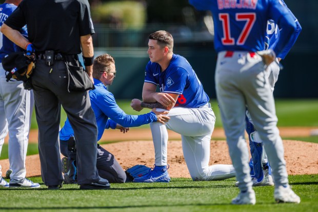 Los Angeles Dodgers pitcher Bobby Miller (28) is checked on after being hit by a pitch from Chicago Cubs first base Michael Busch (29) during the third inning at spring training at Camelback Ranch Thursday Feb. 20, 2025, in Glendale, Arizona. (Armando L. Sanchez/Chicago Tribune)