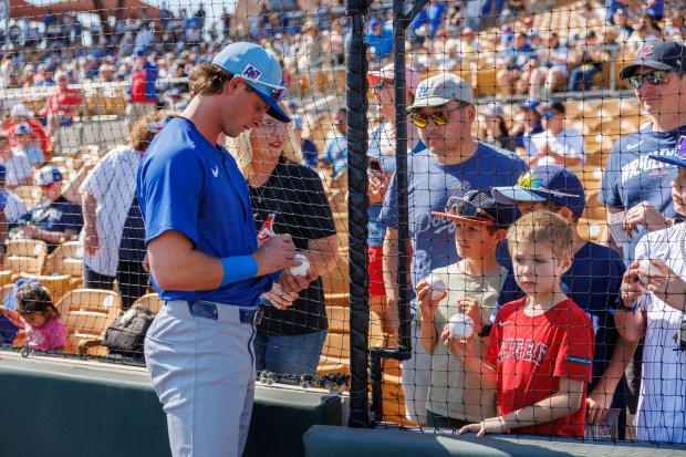 Chicago Cubs third base Benjamin Cowles (79) signs autographs for fans before playing the Los Angeles Dodgers at spring training at Camelback Ranch Thursday Feb. 20, 2025, in Glendale, Arizona. (Armando L. Sanchez/Chicago Tribune)