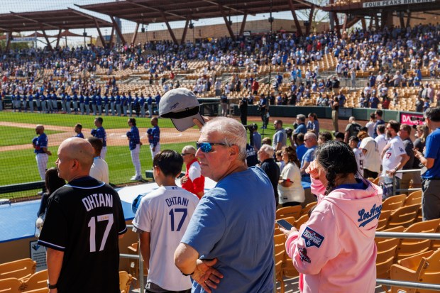 Fans stand for the national anthem before the Chicago Cubs play the Los Angeles Dodgers at spring training at Camelback Ranch Thursday Feb. 20, 2025, in Glendale, Arizona. (Armando L. Sanchez/Chicago Tribune)