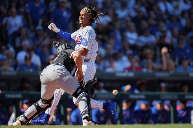 Cubs outfielder Kevin Alcántara scores past White Sox catcher Matt Thaiss during the second inning on Feb. 22, 2025, at Sloan Park in Mesa, Ariz. (Armando L. Sanchez/Chicago Tribune)