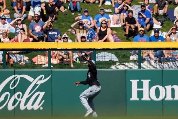 White Sox center fielder Luis Robert Jr. catches a fly ball from Cubs third baseman Nicky Lopez during the second inning on Feb. 22, 2025, at Sloan Park in Mesa, Ariz. (Armando L. Sanchez/Chicago Tribune)