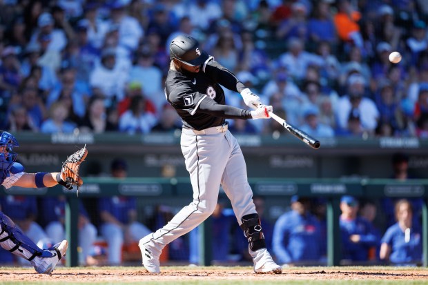 White Sox center fielder Luis Robert Jr. hits a double in the third inning against the Cubs during a Cactus League game on Feb. 22, 2025, at Sloan Park in Mesa, Ariz. (Armando L. Sanchez/Chicago Tribune)