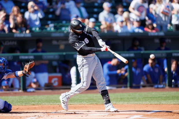 White Sox center fielder Luis Robert Jr. singles in the first inning against the Cubs during a Cactus League game at Sloan Park on Feb. 22, 2025, in Mesa, Ariz. (Armando L. Sanchez/Chicago Tribune)