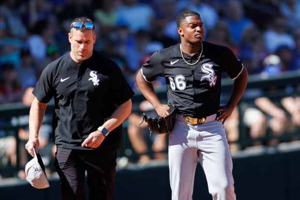 Chicago White Sox pitcher Prelander Berroa (66) walks with a trainer after being taken out of the game during the fourth inning against the Chicago Cubs at spring training at Sloan Park Saturday Feb. 22, 2025, in Mesa, Arizona. (Armando L. Sanchez/Chicago Tribune)