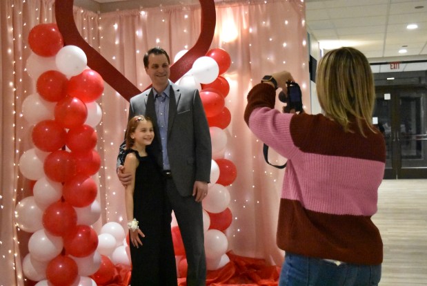 Robin Brey, a Niles Park District supervisor, right, takes photos Feb. 8, 2025 at the "Little Ladies Winter Dance" held at the Howard Leisure Center in Niles. (Jesse Wright/for Pioneer Press)