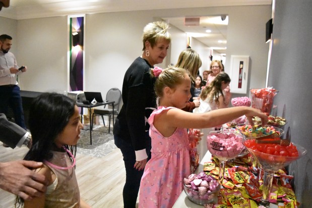 Girls line up at the candy buffet Feb. 8, 2025 at the "Little Ladies Winter Dance" held at the Howard Leisure Center in Niles. (Jesse Wright/for Pioneer Press)